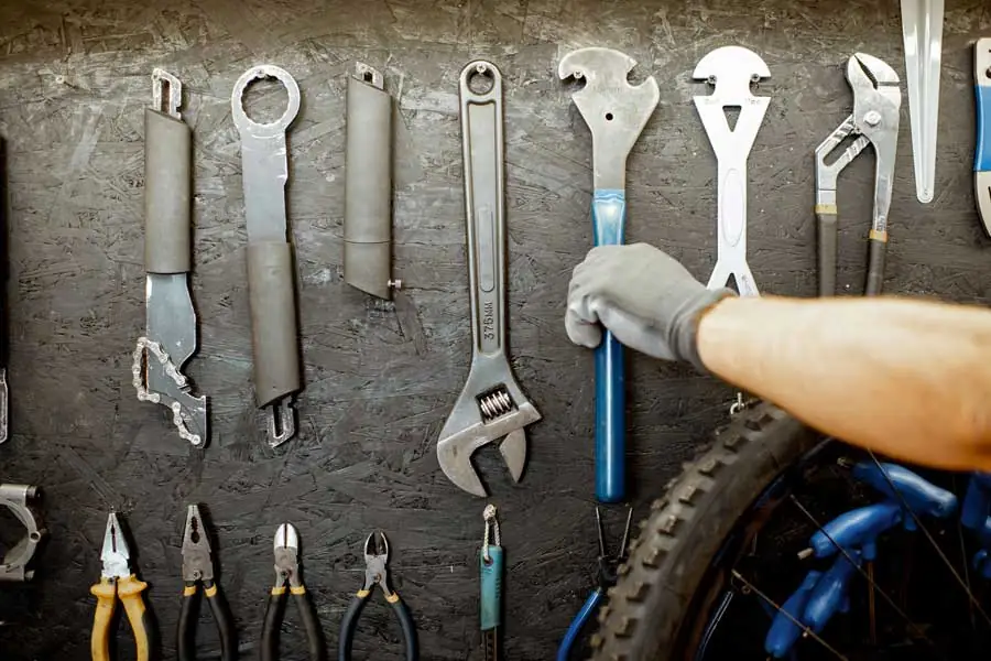 EDC-Fahrradwerkzeugkit – Schraubenschlüssel und Zangen an schwarzer Werkbankwand